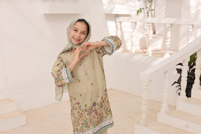 Young girl in a floral dress standing in a white interior setting