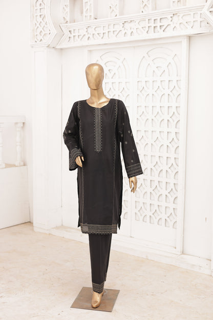 Black traditional outfit on a mannequin against a white decorative wall.
