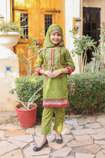 Child wearing a green traditional outfit with a hood in an outdoor setting.