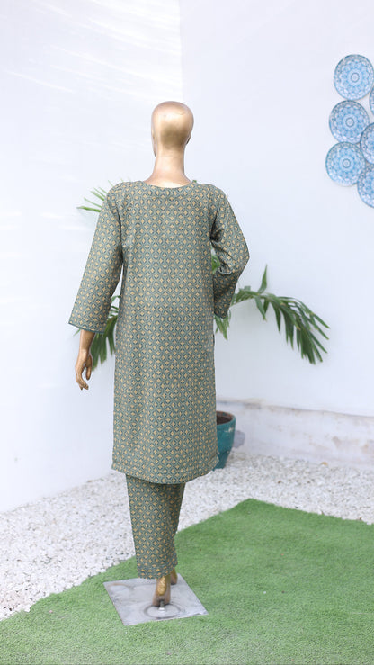 Mannequin wearing a green dress with white polka dots on a white background