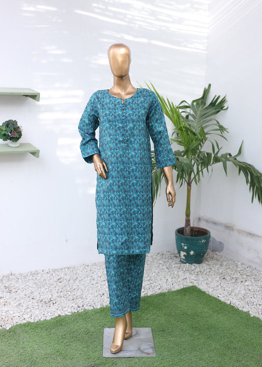 Mannequin wearing a blue patterned outfit in a room with plants and shelves.