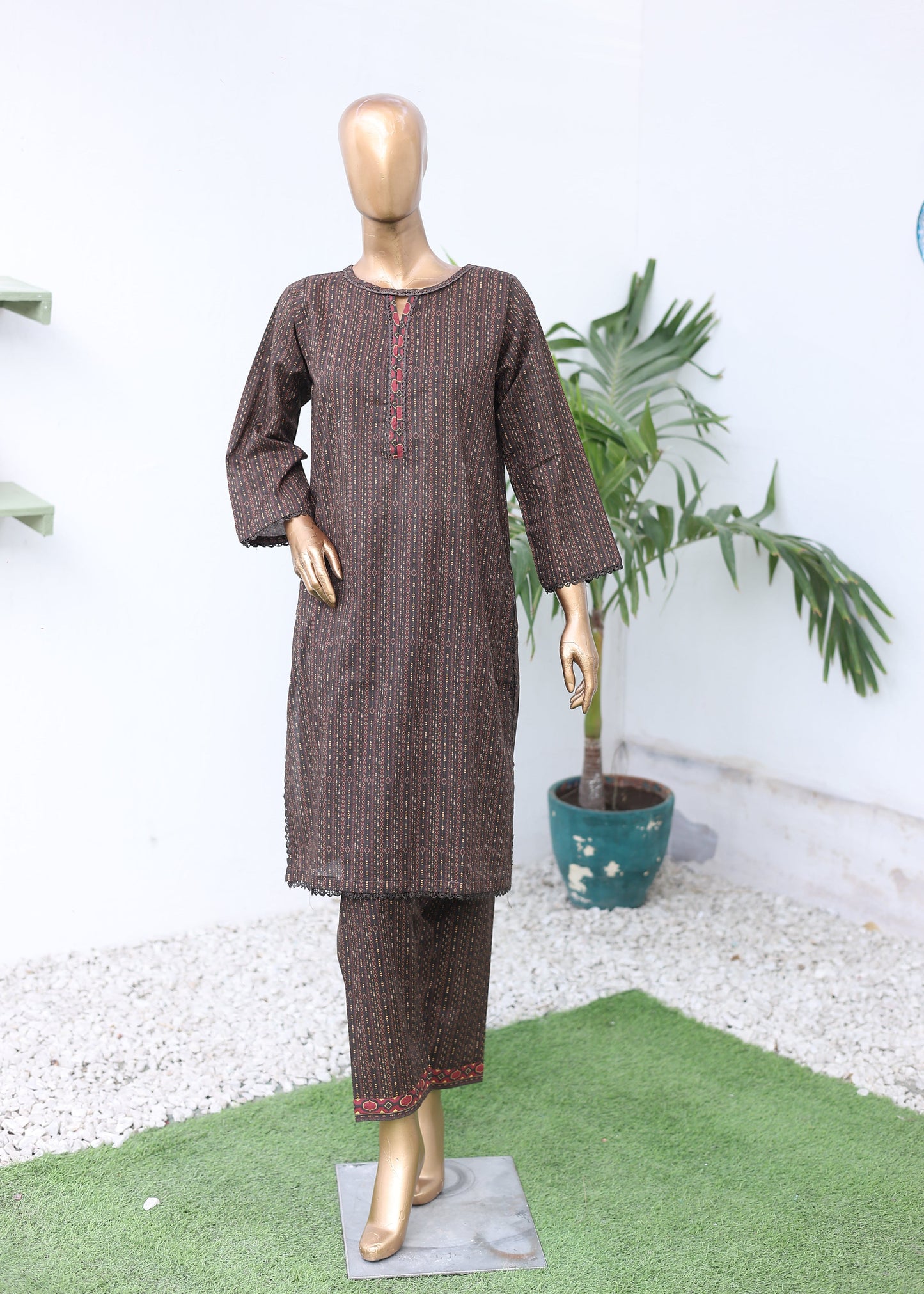Mannequin wearing a brown outfit with a white background
