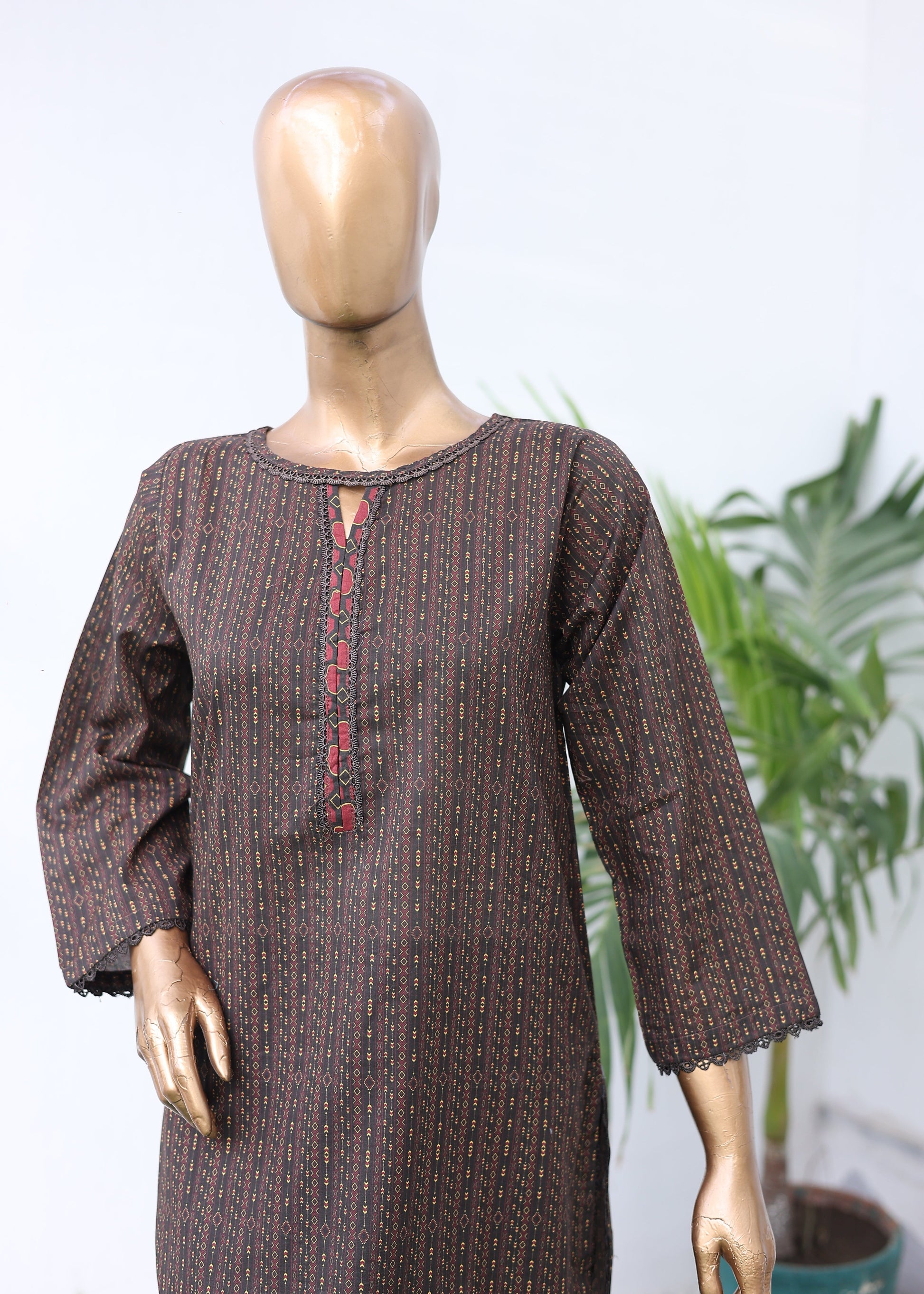 Mannequin wearing a brown textured outfit with a blurred background