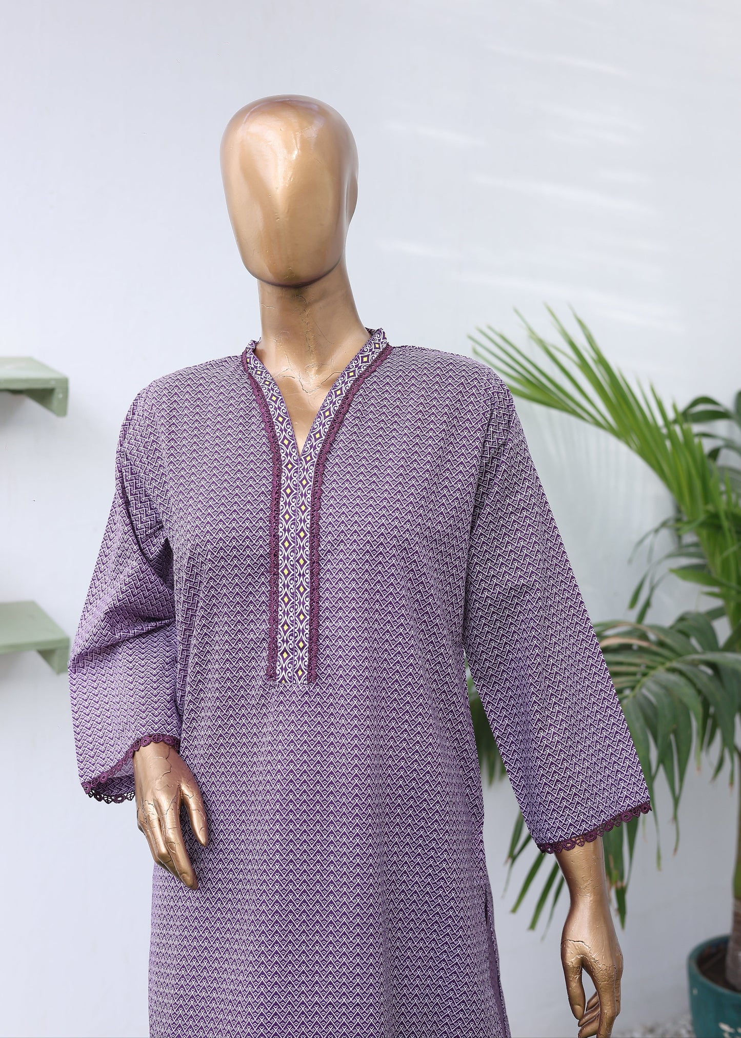 Purple textured dress on a mannequin with a white background