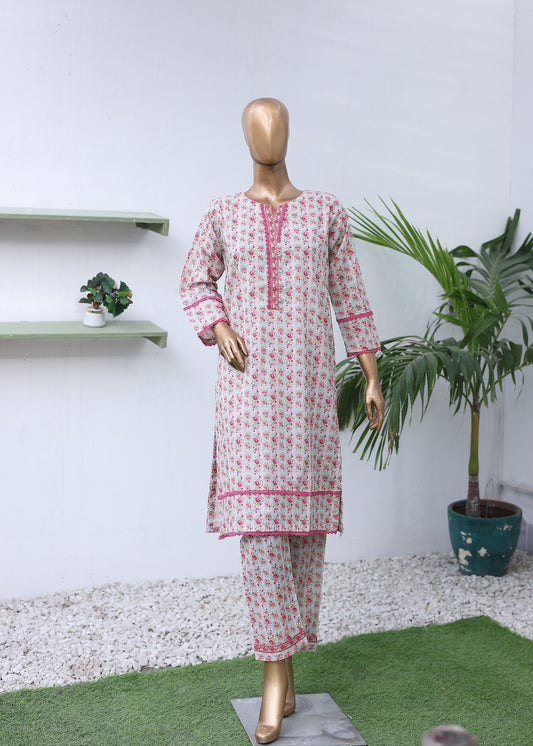 Mannequin wearing a red and white patterned dress on a white background with green plants.