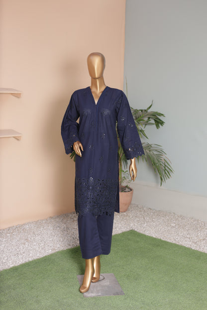 Navy blue dress on a mannequin against a neutral wall with a plant in the background