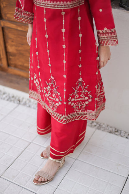 Red embroidered outfit on a tiled floor
