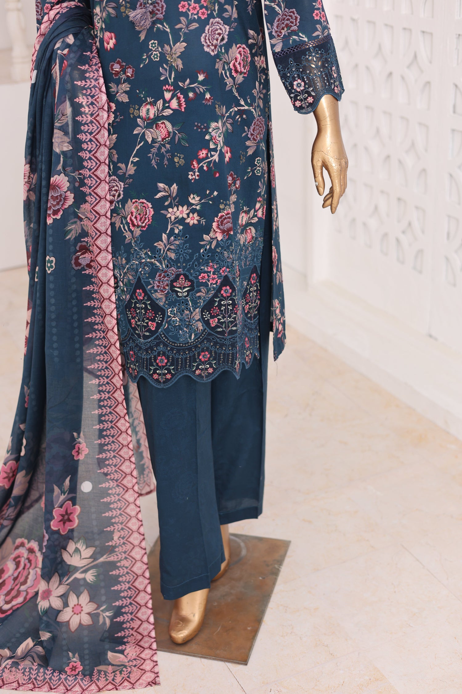 Navy blue floral embroidered outfit on a mannequin against a light background