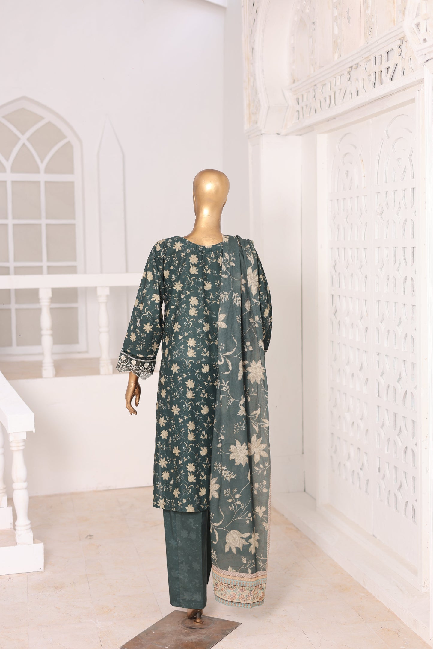 Green floral dress on a mannequin against a white background