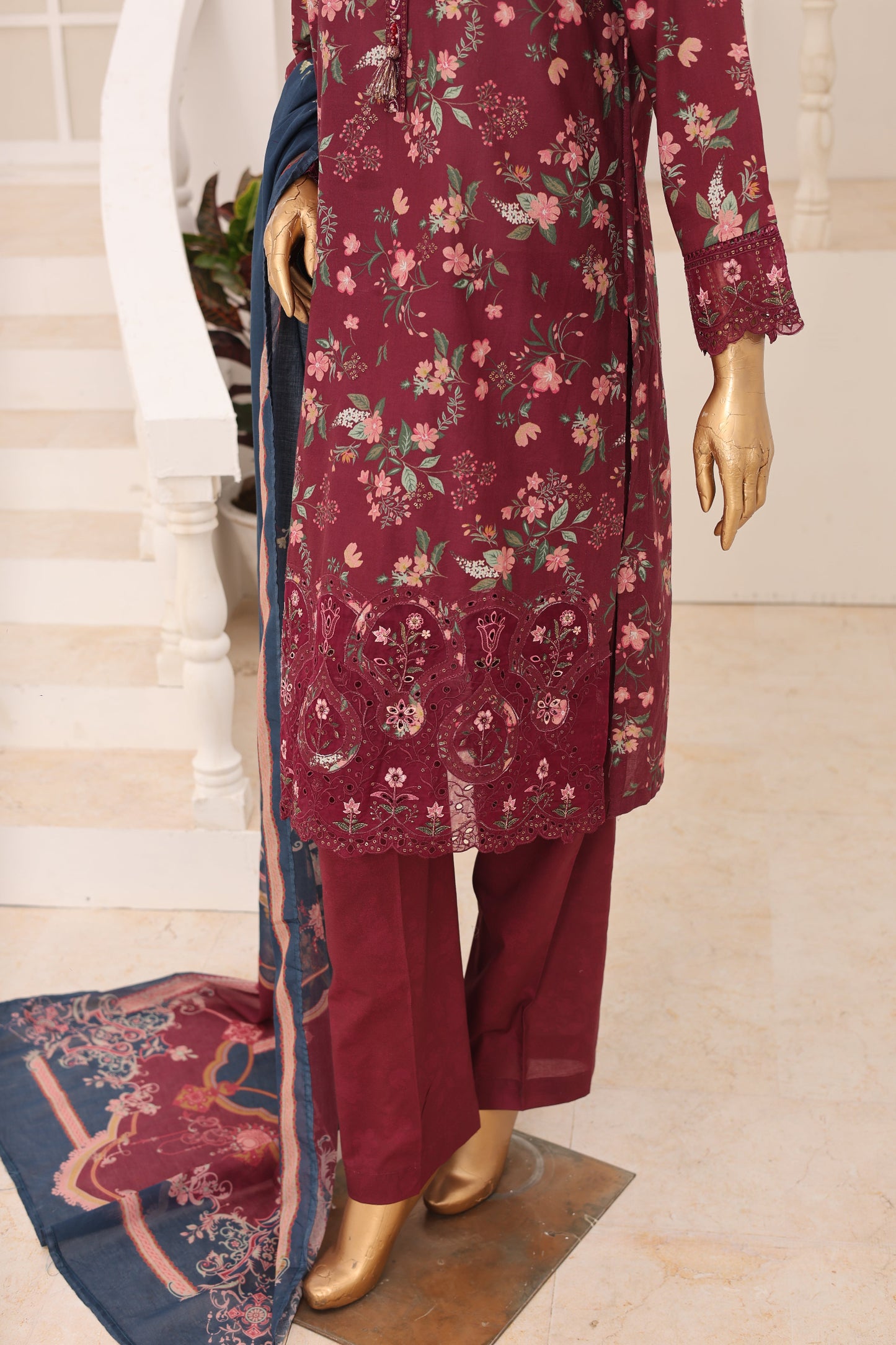Maroon floral dress with matching pants and dupatta on a mannequin against a neutral background