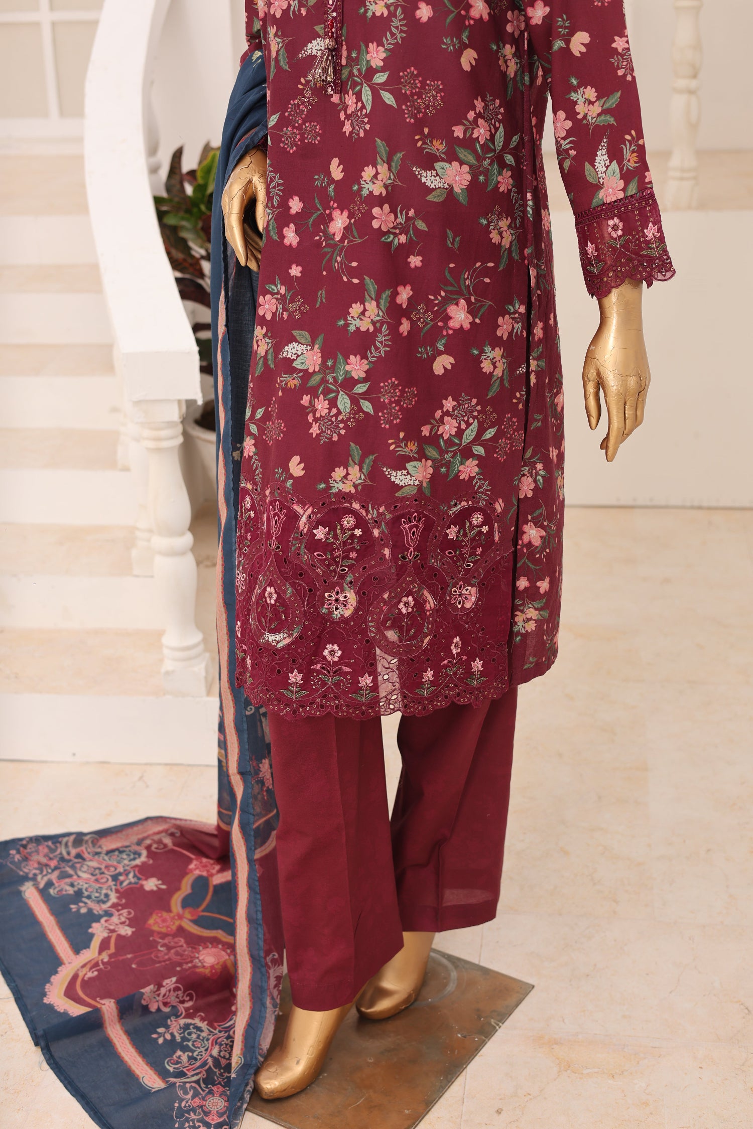 Maroon floral dress with matching pants and dupatta on a mannequin against a neutral background